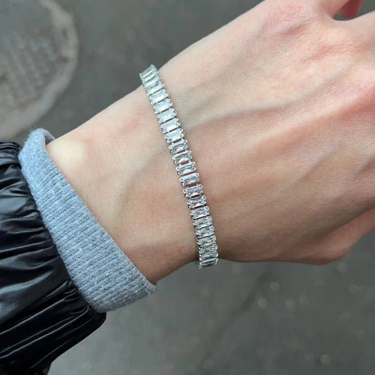 Silver bracelet on a wrist with a blurred background