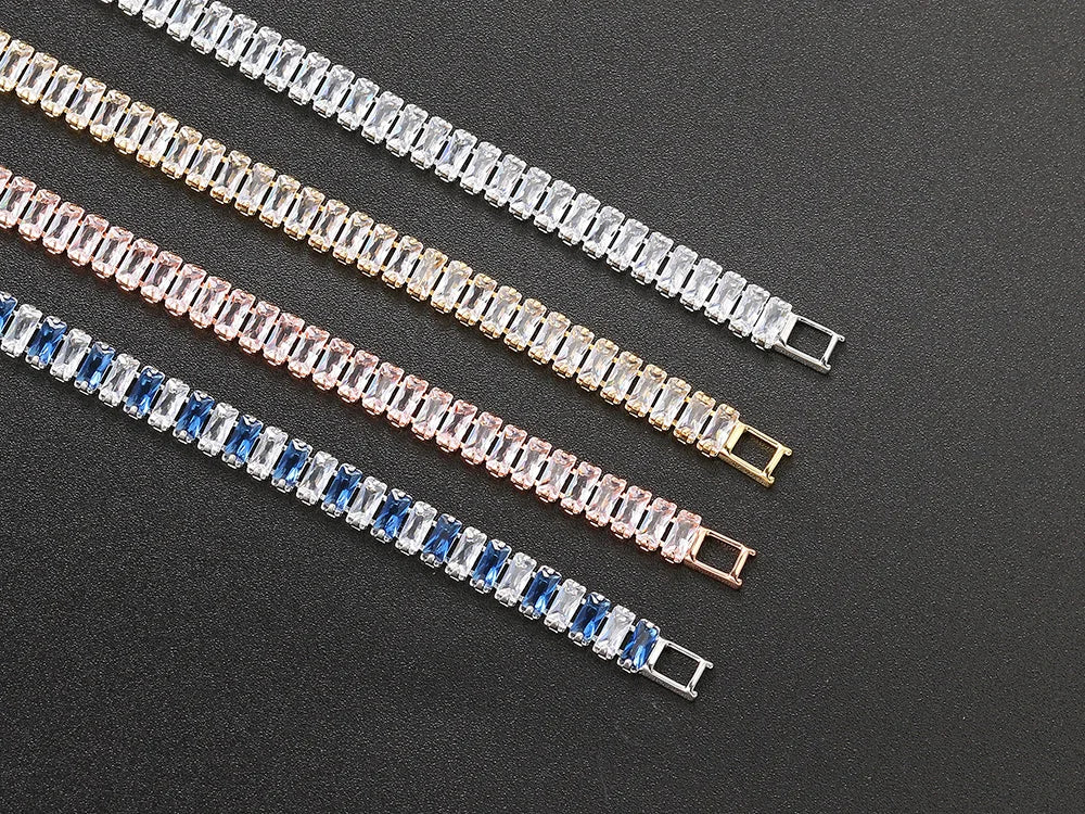 Three bracelets with different colored stones on a dark background