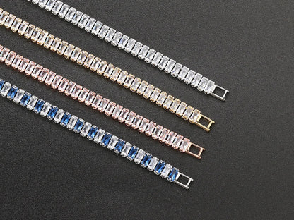 Three bracelets with different colored stones on a dark background